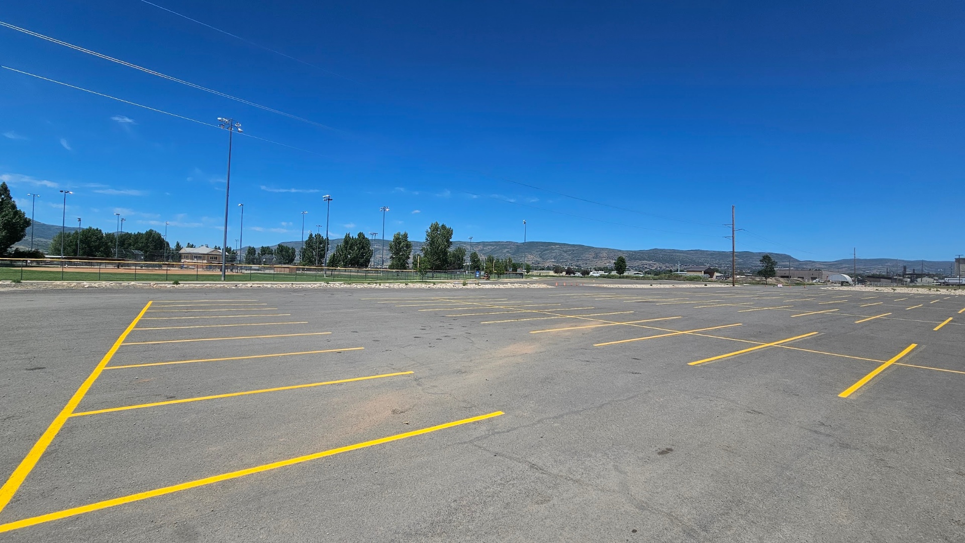 Yellow parking stalls at a sports complex lot